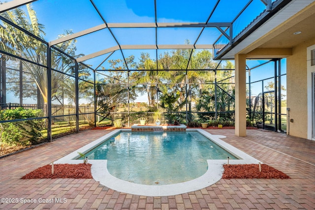 view of pool featuring a lanai, pool water feature, and a patio