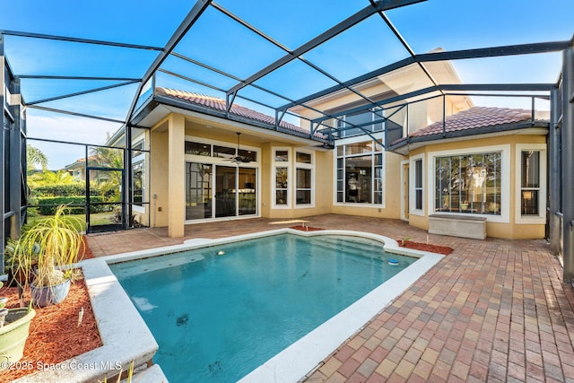 view of swimming pool featuring a patio, ceiling fan, and a lanai