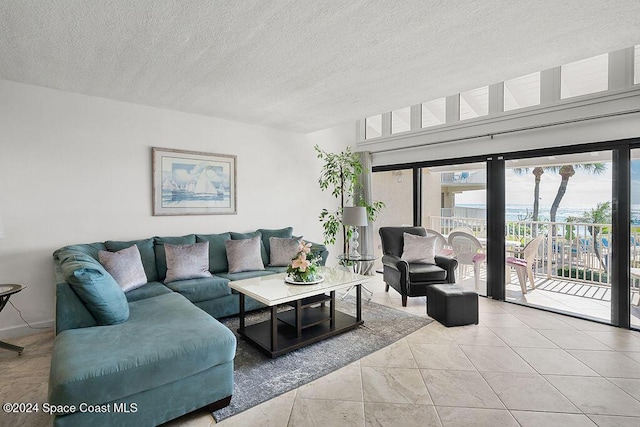 living room featuring light tile patterned floors and a textured ceiling