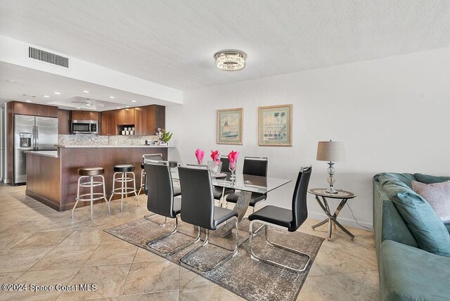 dining space featuring a textured ceiling