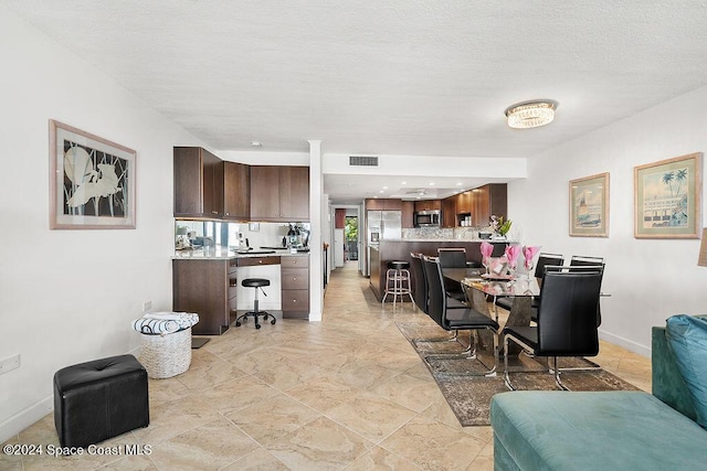 dining space featuring a textured ceiling