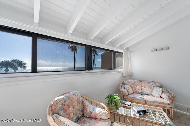 living area with lofted ceiling with beams