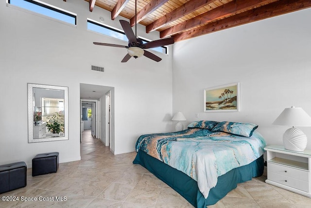 bedroom with ceiling fan, beam ceiling, wood ceiling, and a towering ceiling