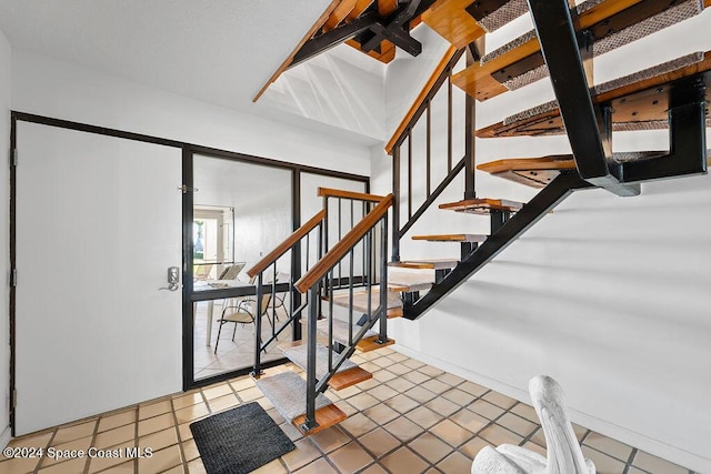 staircase featuring tile patterned flooring