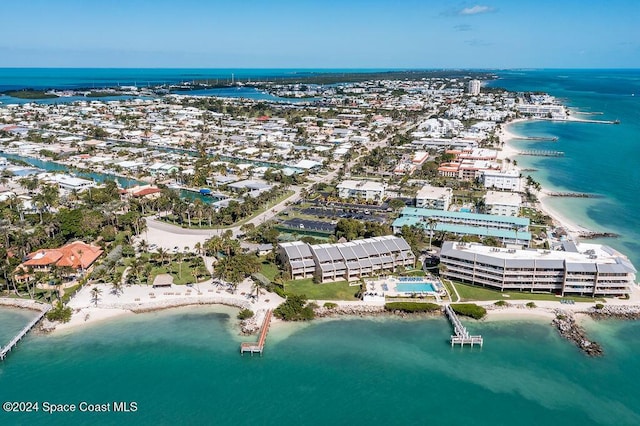 bird's eye view featuring a water view and a beach view