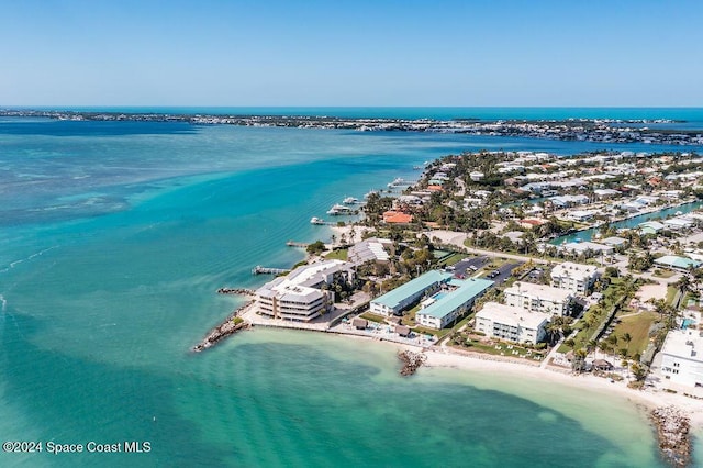 aerial view with a water view and a beach view