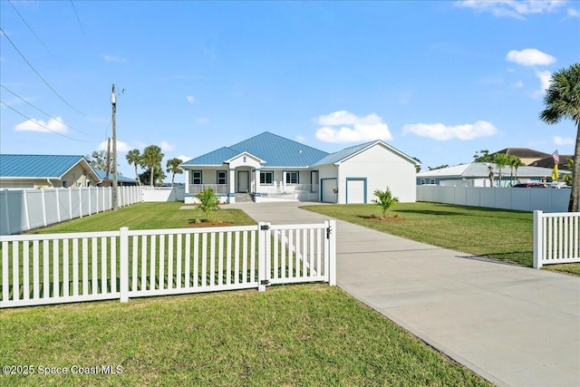 view of front of house featuring a front yard, a garage, a fenced front yard, and metal roof