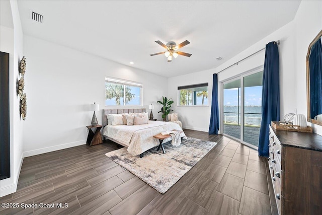 bedroom with visible vents, wood finish floors, baseboards, and access to outside