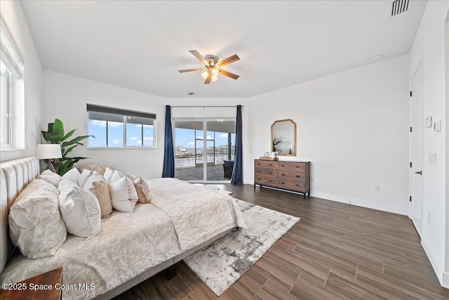 bedroom featuring a ceiling fan, visible vents, baseboards, dark wood-style flooring, and access to exterior