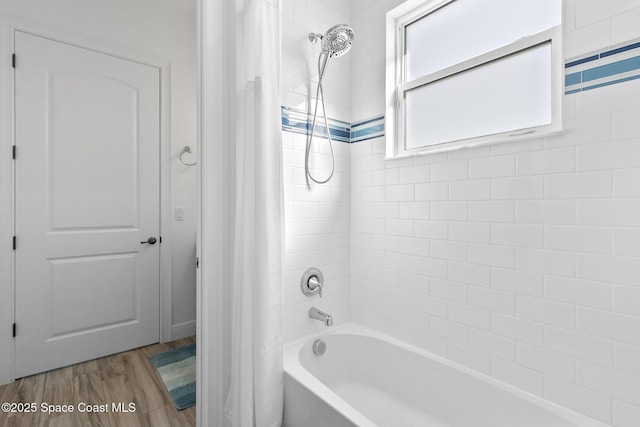 bathroom featuring shower / tub combo with curtain and wood finished floors