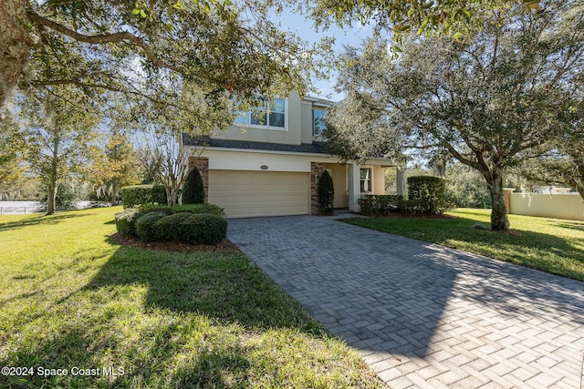 view of property with a garage and a front yard