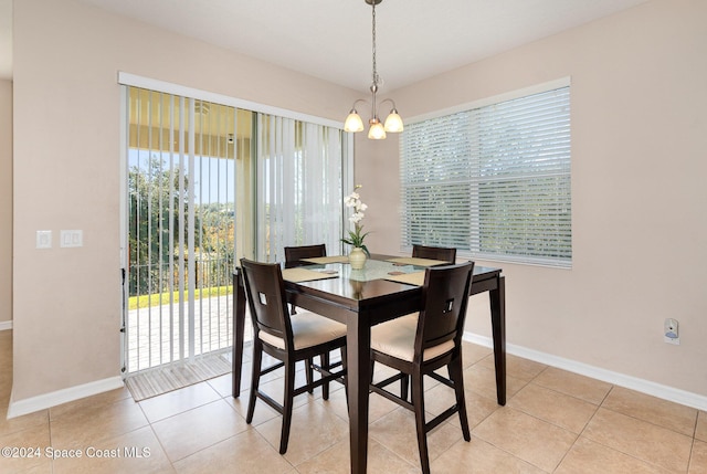 dining room featuring light tile patterned floors and a notable chandelier