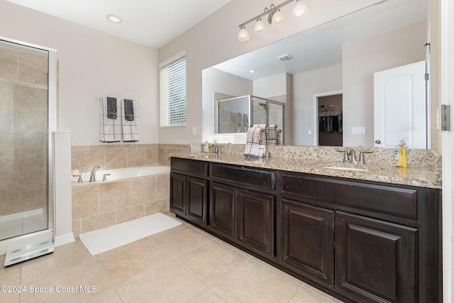 bathroom with separate shower and tub, tile patterned floors, and vanity