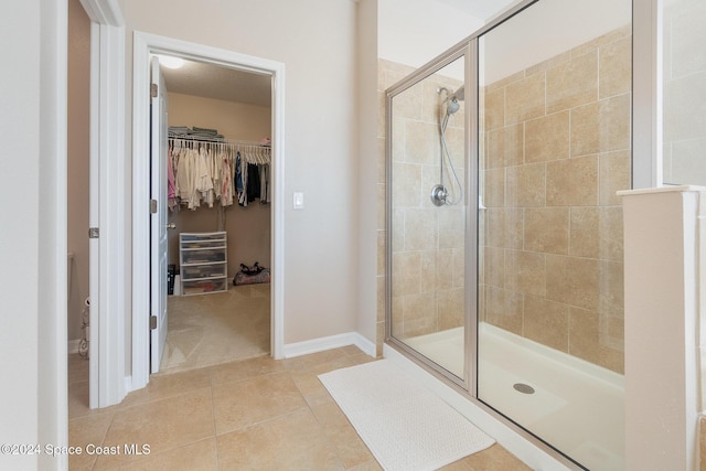 bathroom with tile patterned flooring and an enclosed shower