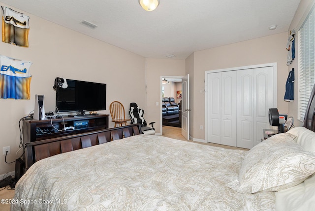 bedroom with a textured ceiling and a closet