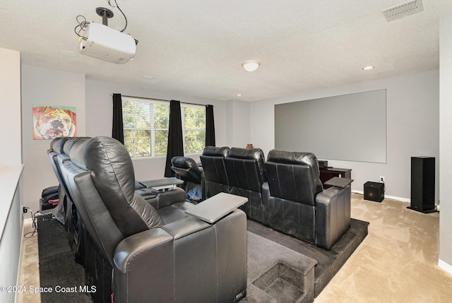 cinema room with light colored carpet and a textured ceiling