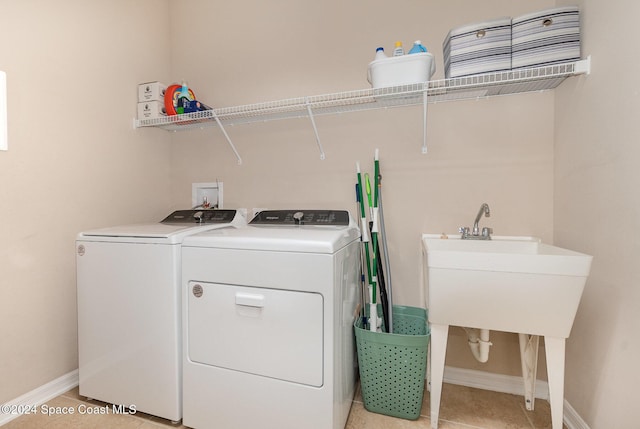 laundry room with light tile patterned flooring and separate washer and dryer