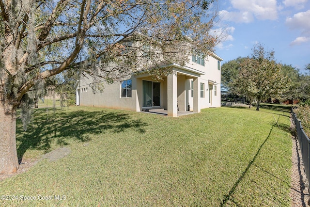 back of house featuring a yard