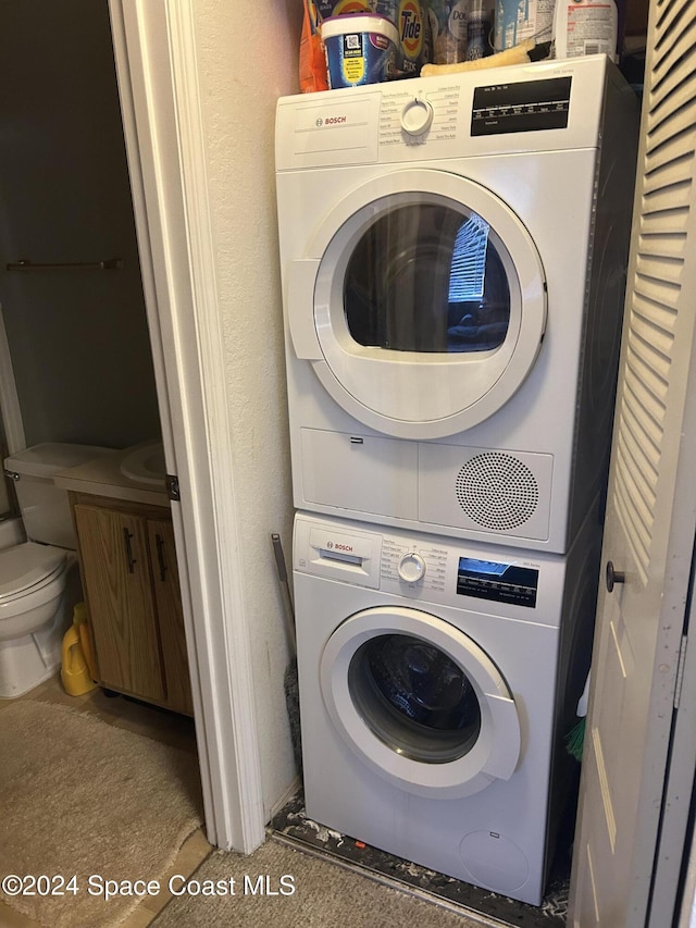 washroom with stacked washer / drying machine