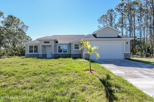 view of front of property featuring a garage and a front lawn