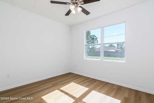 spare room featuring ceiling fan and light hardwood / wood-style floors