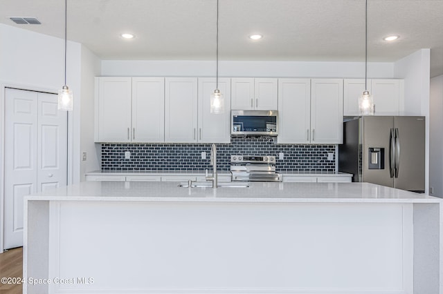 kitchen featuring stainless steel appliances, white cabinetry, a center island with sink, and sink