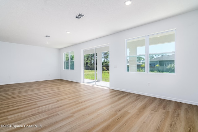 unfurnished room with light wood-type flooring