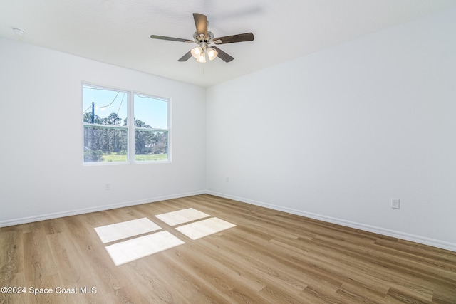 empty room featuring ceiling fan and light hardwood / wood-style floors