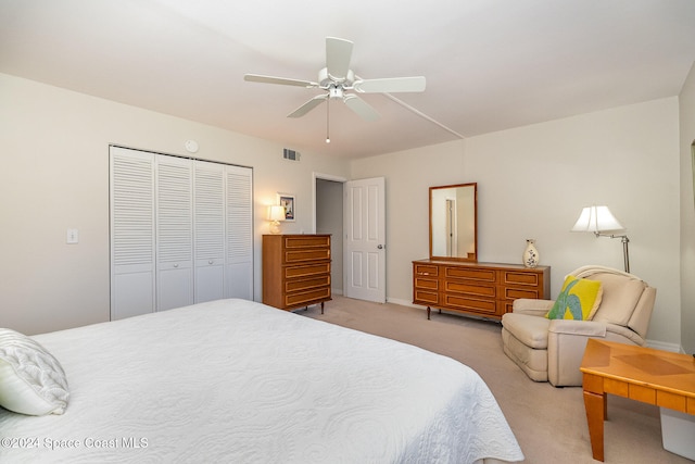 bedroom featuring light carpet, a closet, and ceiling fan