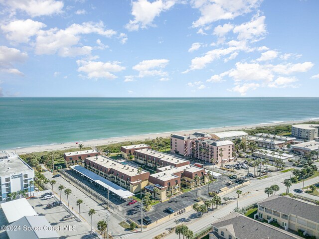 drone / aerial view featuring a water view and a beach view