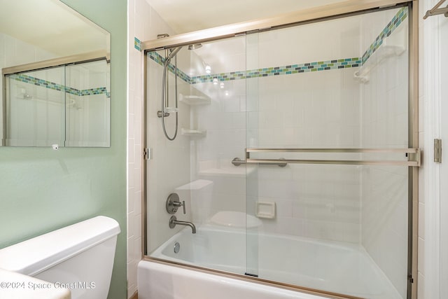 bathroom featuring toilet and enclosed tub / shower combo