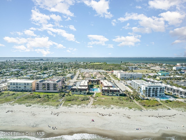 drone / aerial view featuring a beach view and a water view