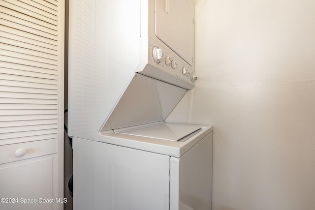 laundry room with stacked washing maching and dryer