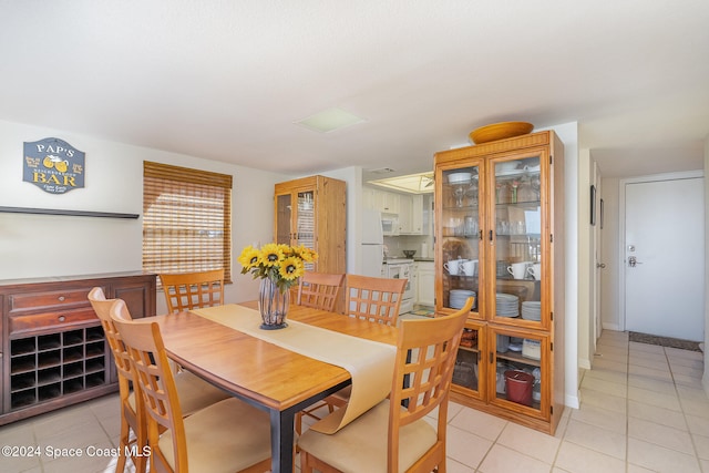 dining space featuring light tile patterned floors