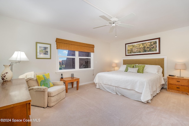 bedroom with ceiling fan and light carpet