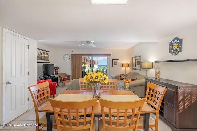 tiled dining space with ceiling fan