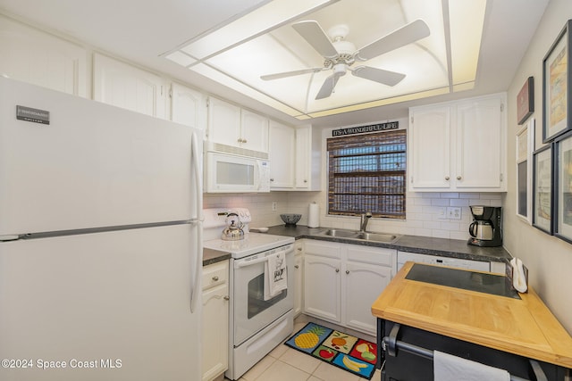 kitchen with decorative backsplash, white cabinetry, white appliances, and sink