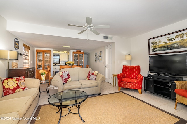 living room with ceiling fan and light tile patterned floors