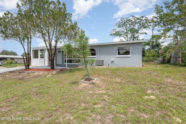 view of front facade with a front lawn and central AC unit