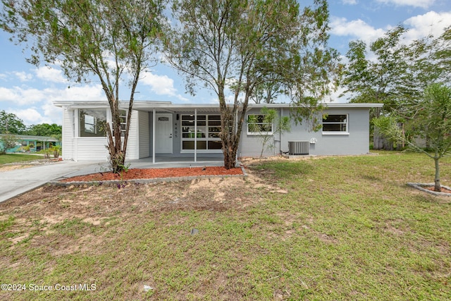 single story home featuring central AC unit and a front yard