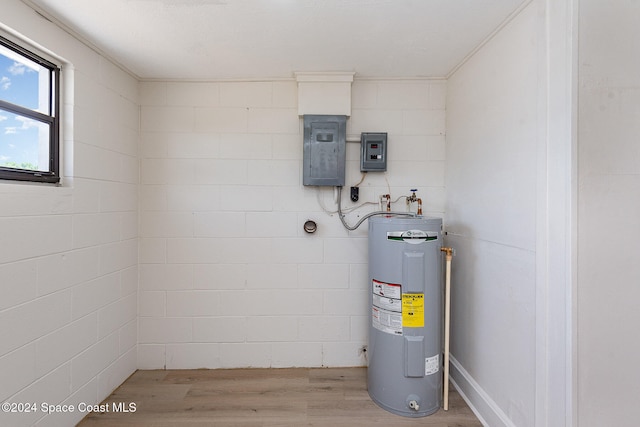 utility room featuring electric panel and water heater