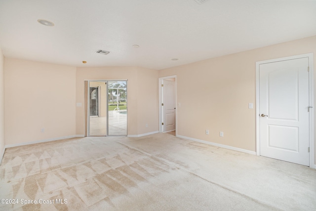 spare room featuring light colored carpet