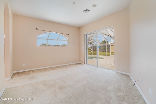 unfurnished room with plenty of natural light and light colored carpet