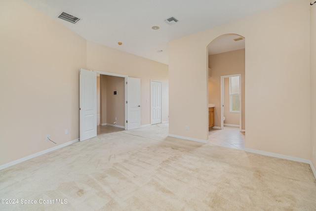 unfurnished room with light colored carpet