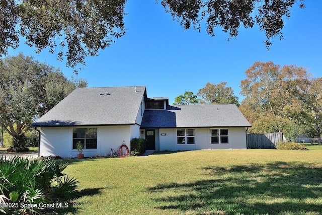 back of house with a lawn