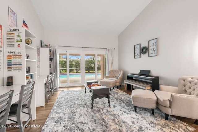 interior space featuring hardwood / wood-style floors, a pool, and vaulted ceiling