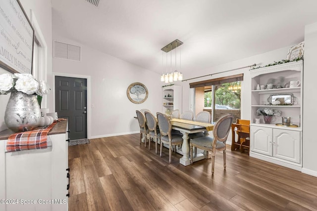 dining space with built in shelves, lofted ceiling, and dark wood-type flooring