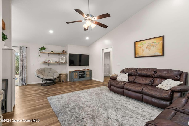 living room with hardwood / wood-style floors, high vaulted ceiling, and ceiling fan