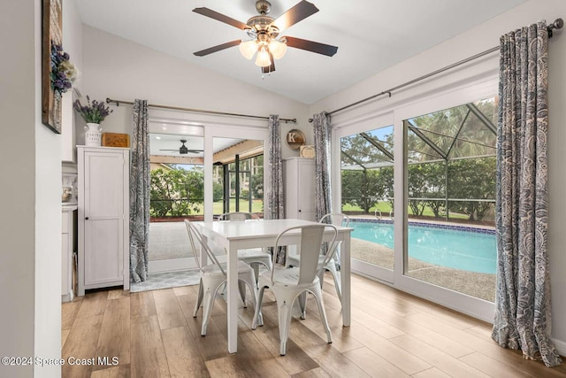 dining space with light wood-type flooring, plenty of natural light, lofted ceiling, and ceiling fan