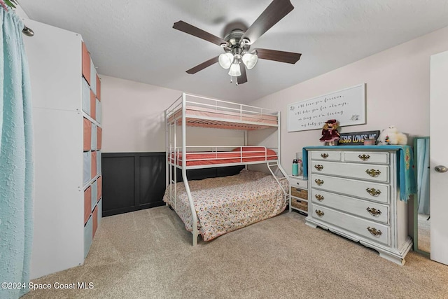 bedroom featuring ceiling fan and light carpet